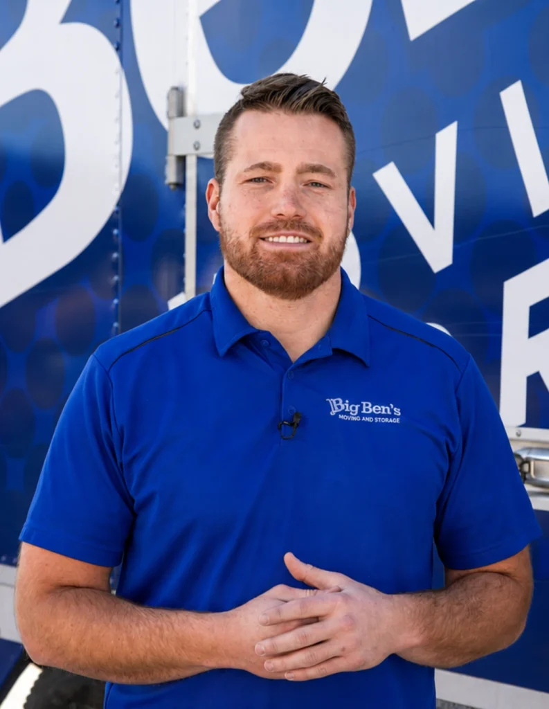Ben Gottfredson, founder of Big Ben’s Moving & Storage, standing in front of a branded moving truck